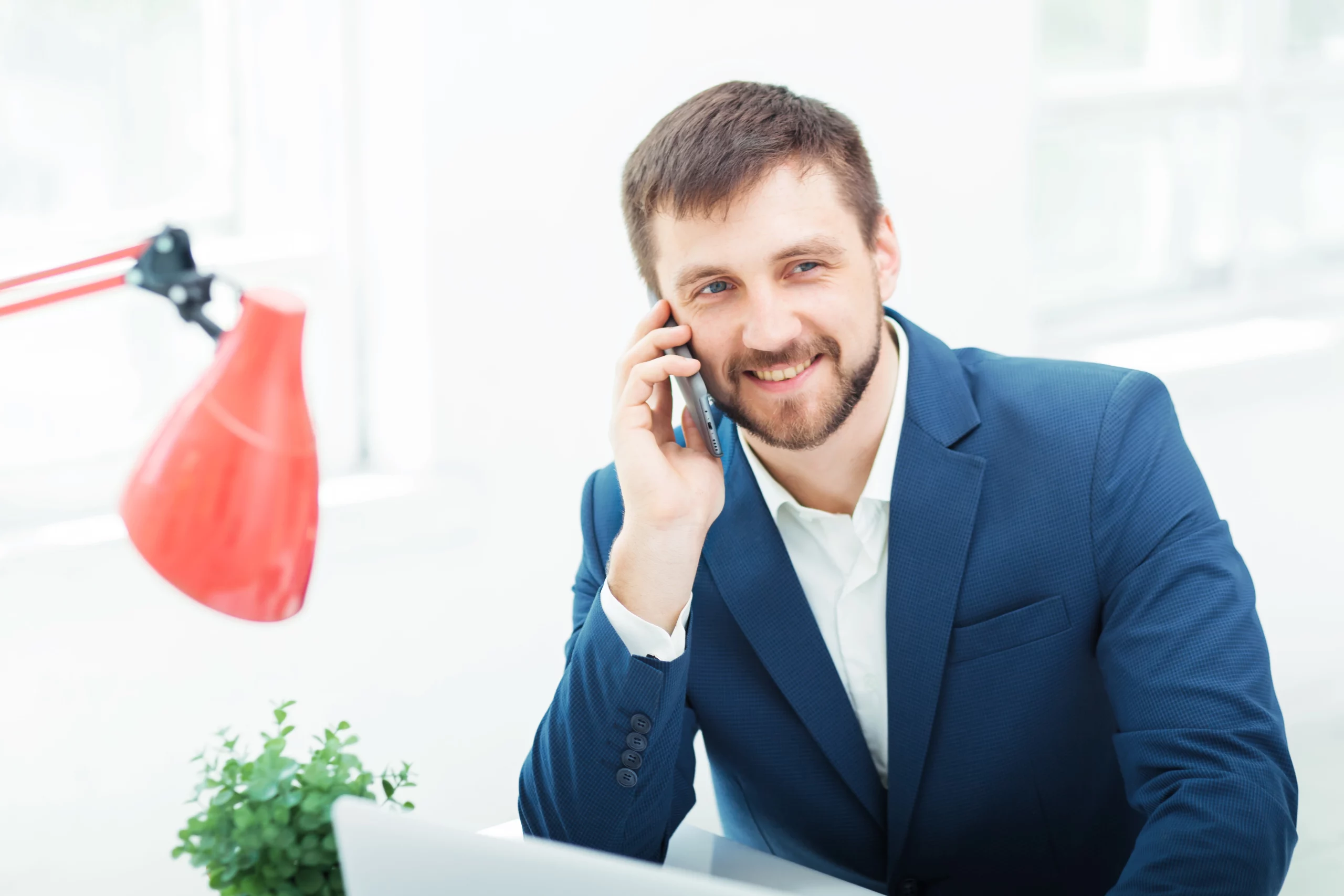 portrait-businessman-talking-phone-office